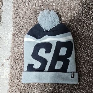 Gray and Black nike.\nS b Knit Beanie with Pom Pom